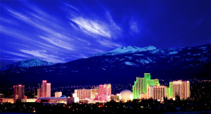 A city skyline with mountains in the background.